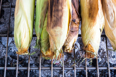 Corn is grilled on grill grates, thailand street food