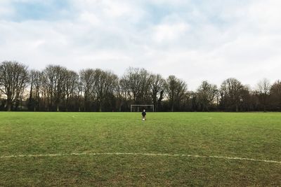 Boy playing soccer on field