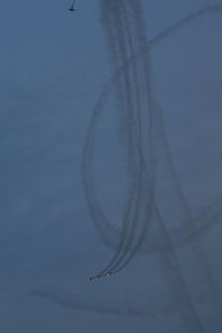 Low angle view of airplane flying against sky