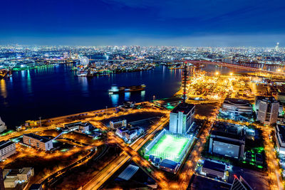 High angle view of illuminated buildings in city at night