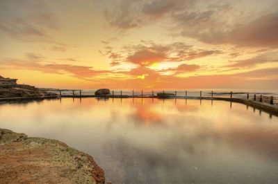 Scenic view of lake against sky during sunset