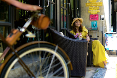 Rear view of man riding bicycle on street