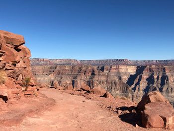 Rock formations on landscape against clear sky