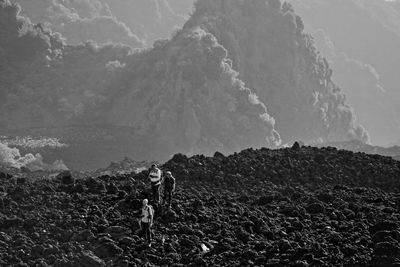 Men on volcanic landscape