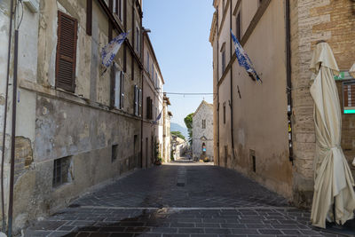 Narrow alley amidst buildings in city