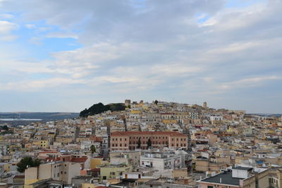 Cityscape against cloudy sky