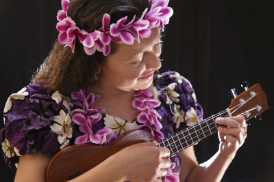 Close-up of woman playing guitar