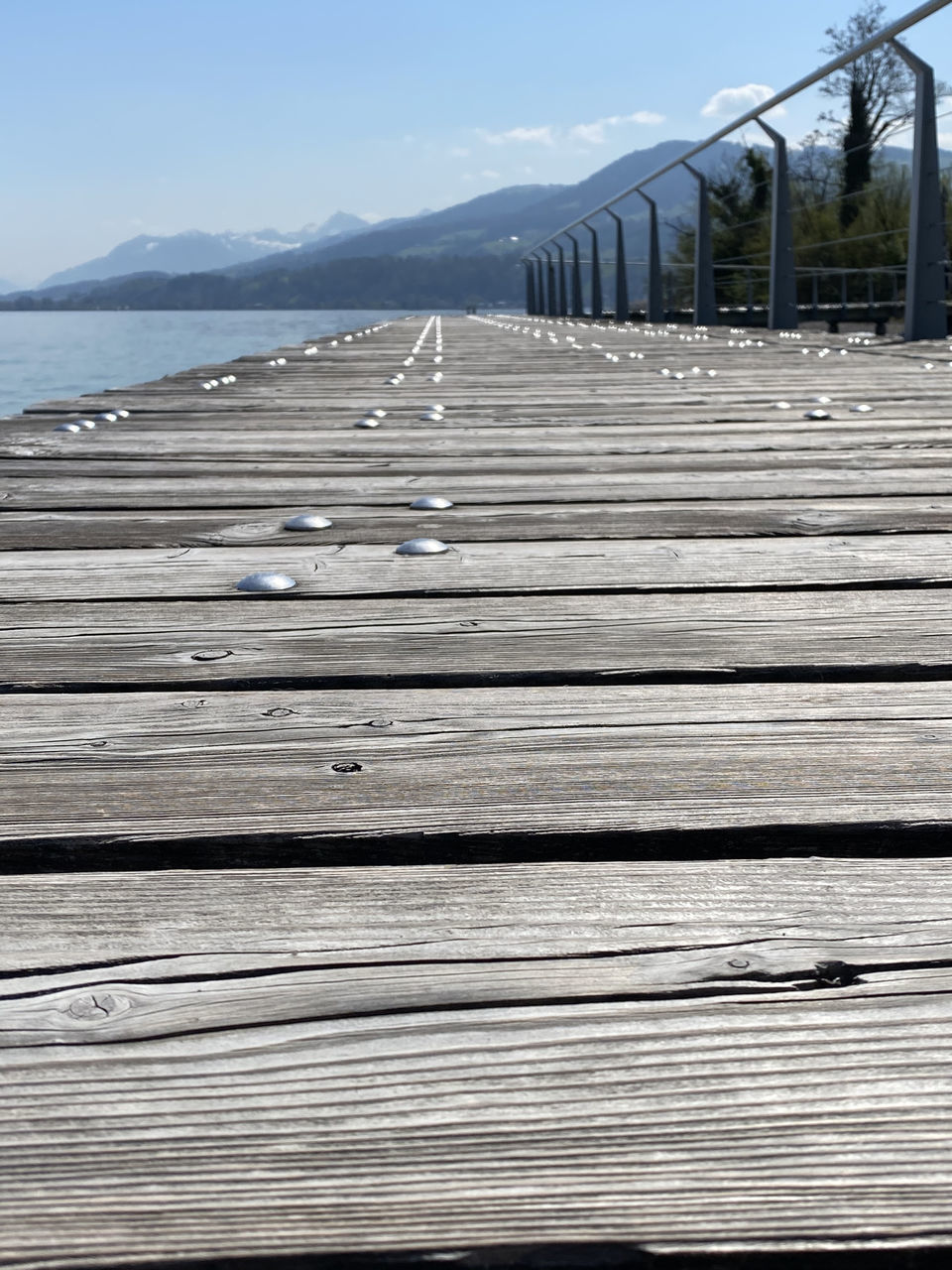 WOODEN PIER ON SEA AGAINST SKY