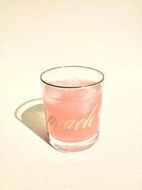 Close-up of drink served on table against white background