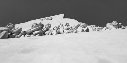 Low angle view of statues against sky