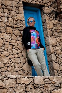 Portrait of young man standing on wall