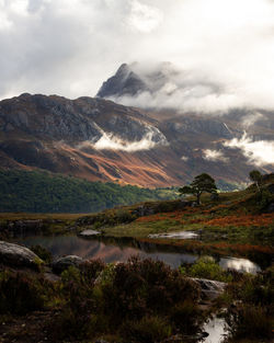 Scenic view of lake and mountains against sky