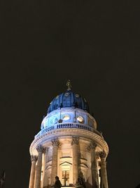 Low angle view of illuminated building against sky at night