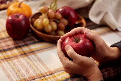 Picnic with fruits, pumpkins and pie outdoor woman hands