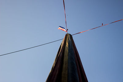 Low angle view of flag against clear sky