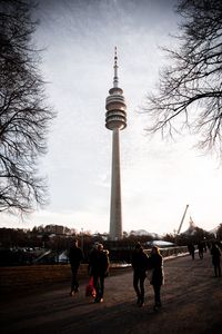 Group of people in front of communications tower