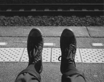 Low section of man at railroad station platform