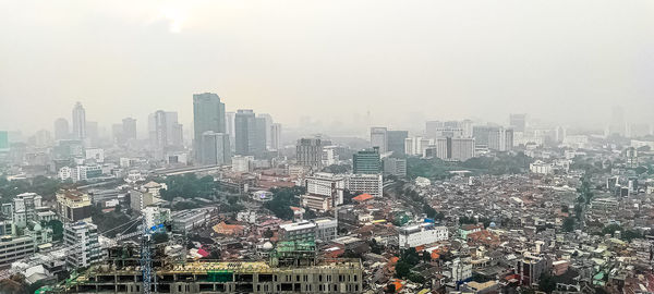 Aerial view of city buildings against clear sky