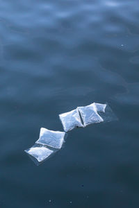 High angle view of plastic floating on water