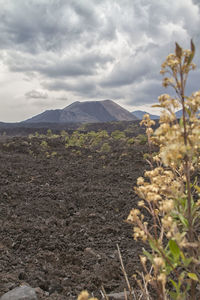 Scenic view of mountains against cloudy sky