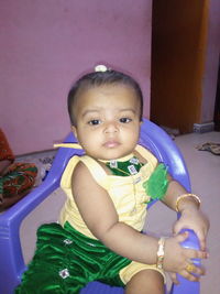 Portrait of cute baby sitting at home