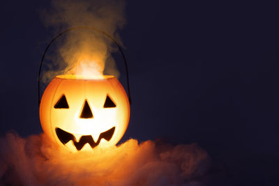 Close-up of illuminated pumpkin against black background