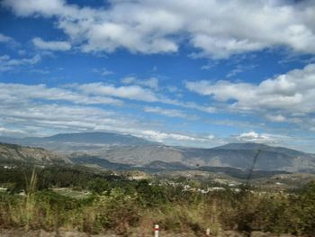 Scenic view of mountains against cloudy sky