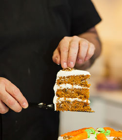 Carrot cake with cream cheese frosting and little carrots on top