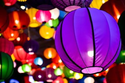 Low angle view of illuminated lanterns hanging at night