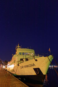 Text on boat against sky at night