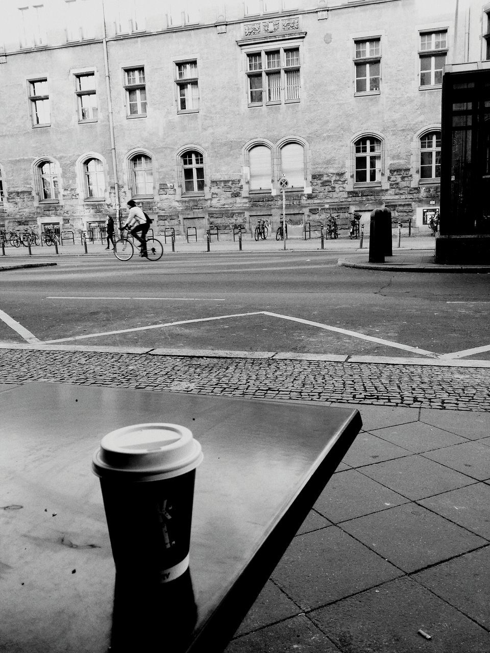 drink, refreshment, table, food and drink, built structure, building exterior, architecture, text, drinking glass, still life, glass - material, freshness, day, close-up, western script, window, coffee cup, no people, cafe, coffee - drink