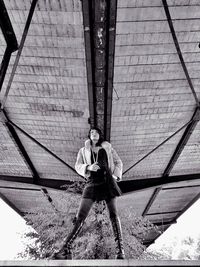 Full length of woman standing by railing