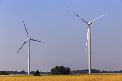 Windmill on field against sky