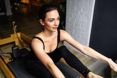 Young woman exercising at gym