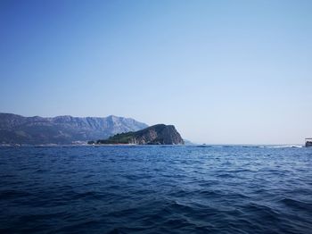 Scenic view of sea against clear blue sky