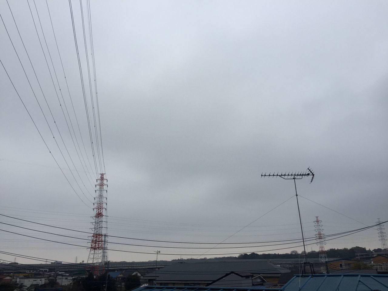 power line, electricity pylon, electricity, power supply, cable, sky, connection, fuel and power generation, building exterior, built structure, technology, low angle view, architecture, power cable, cloud - sky, outdoors, transportation, no people, city, day