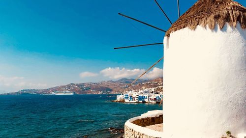 Scenic view of sea by city against sky