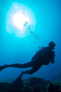 Low angle view of man swimming in sea