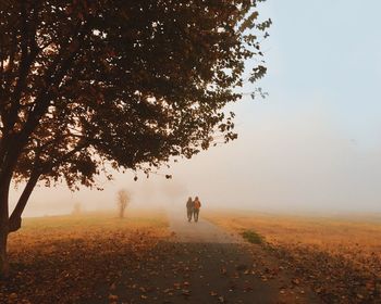 Silhouette of woman standing on field