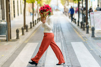 Full length of woman walking on street