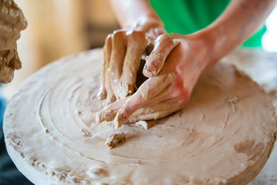 Cropped hand of person making pottery