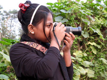 Young woman photographing through camera