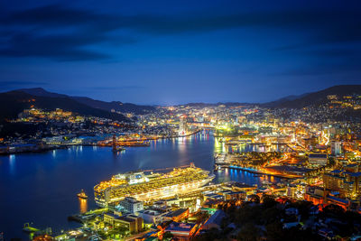 High angle view of illuminated cityscape against sky at night