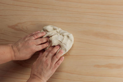 High angle view of woman hand on table