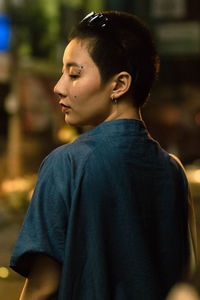 Rear view of young woman standing outdoors