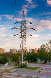 Electricity pylon against sky during sunset