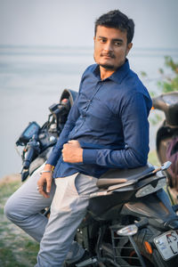 Portrait of young man sitting outdoors