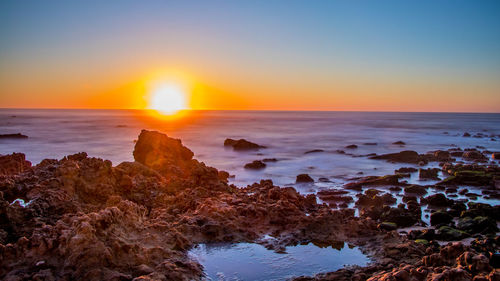 Scenic view of sea against sky during sunset