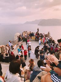 High angle view of people at observation point against sea