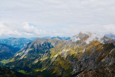 Scenic view of valley and mountains against sky